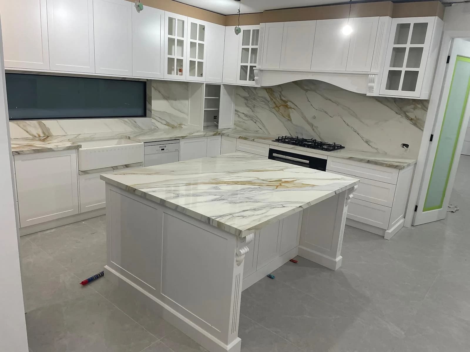 Kitchen cabinetry being fitted around a central island in the H&R Kitchens portfolio