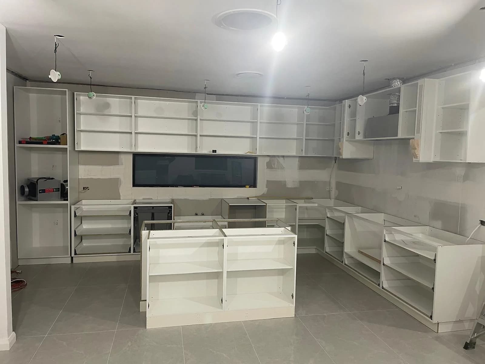 Kitchen cabinetry and island installation in progress in the H&R Kitchens portfolio