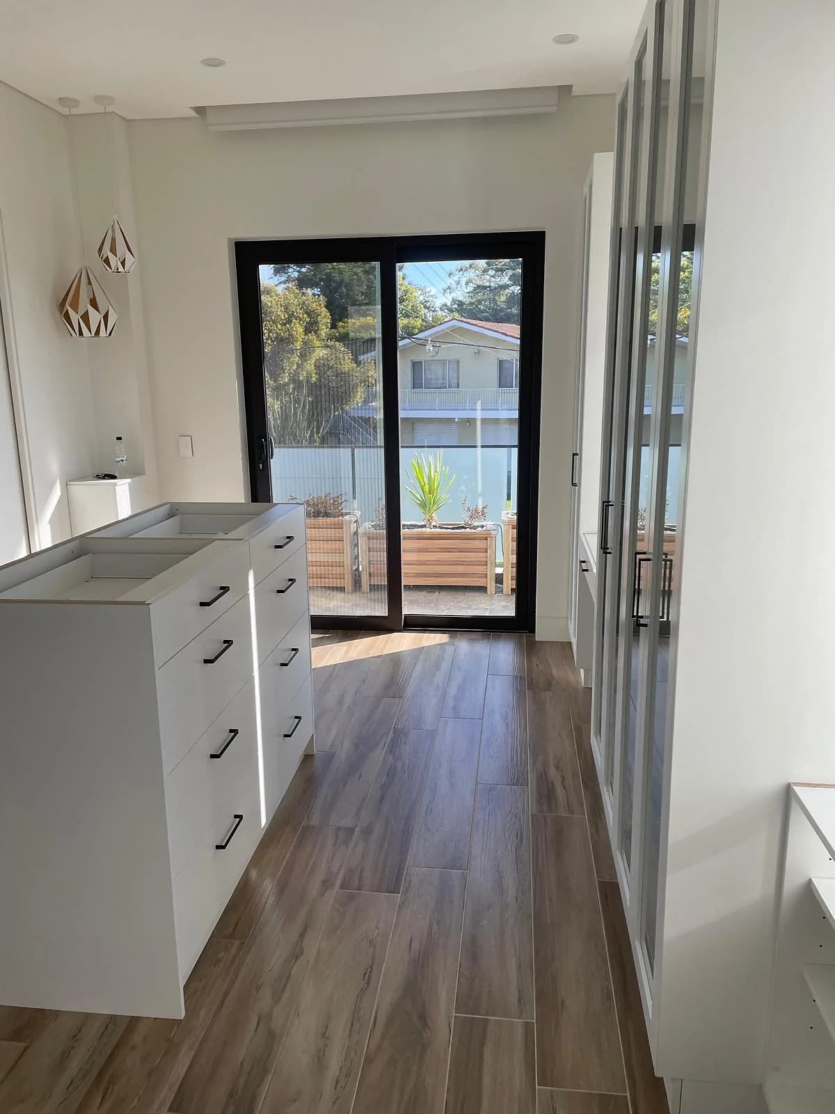 Fitted wardrobe storage with shelving and drawer cabinetry by H&R Kitchens