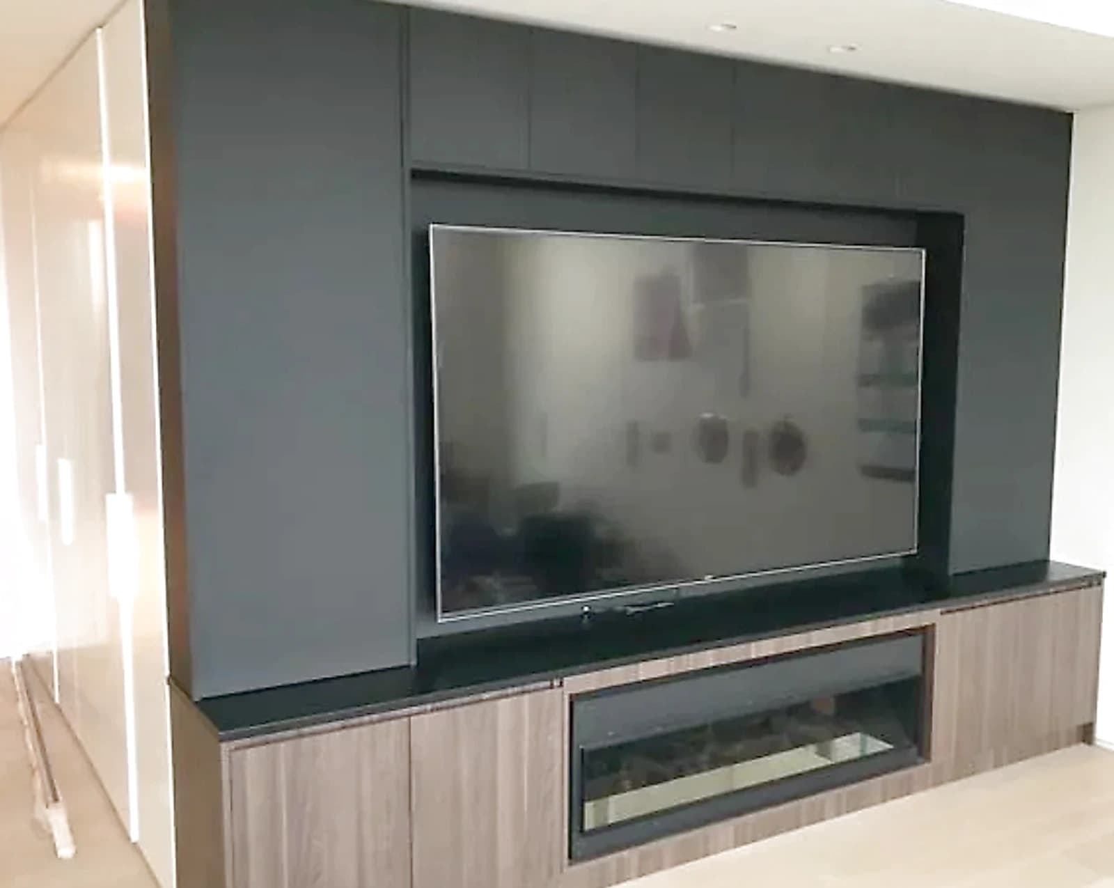 Completed entertainment wall with low storage and display shelving in Strathfield