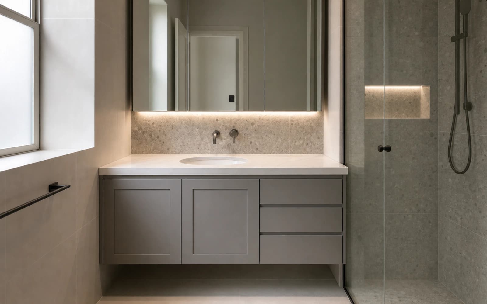Custom bathroom vanity with grey shaker cabinetry, a stone benchtop, an undermount basin and a mirrored cabinet by H&R Kitchens